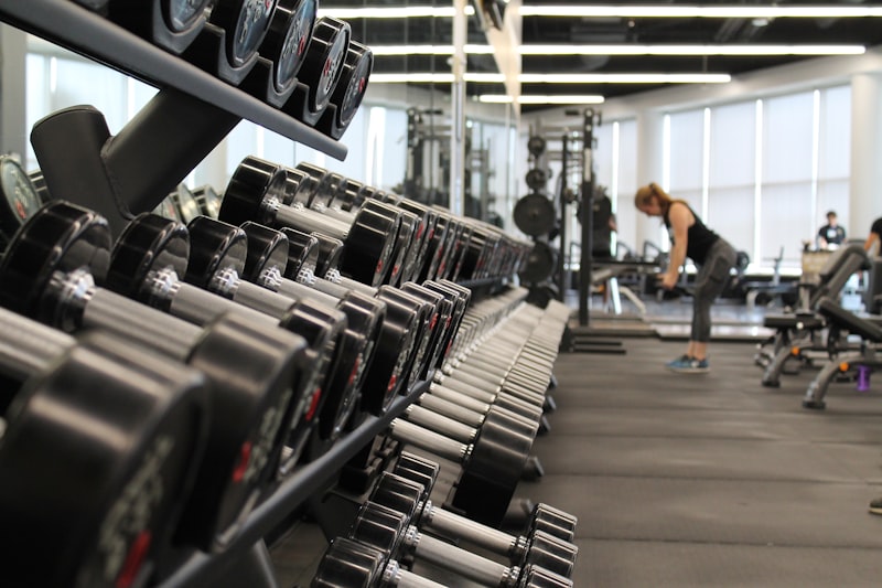 Gym equipment including dumbbells and barbells